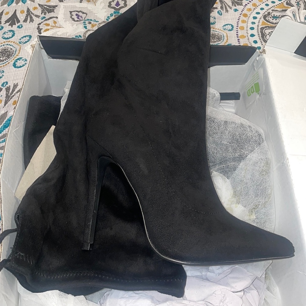 Never been worn Size thigh high black boots size 5 1/2